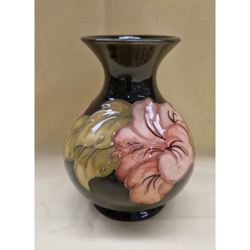 454 - Moorcroft pottery vase, hibiscus on dark green ground, height 13cm