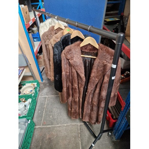 439 - A clothes rail of vintage women's 50's & 60's clothing containing 4 fur coats and a group of fur sto... 