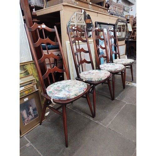 1025 - A set of four vintage Ercol dark elm 'Batwing' chairs, model number 496.