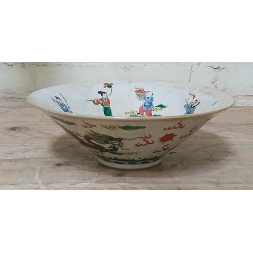 83 - A Chinese porcelain bowl, circa 1900, crackle glaze with over enamel decoration depicting figures to... 