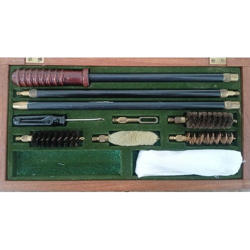 64 - An Aguinaga boxed gun cleaning kit.