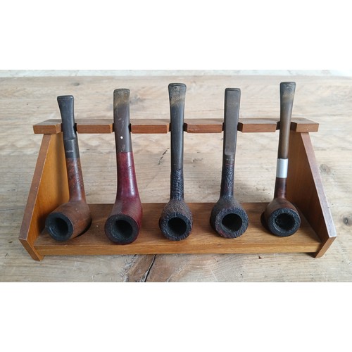 100 - A vintage pipe rack and pipes comprising Dunhill, Dr Pat, Barling and Keyler.