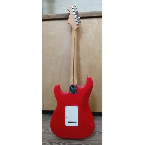 134 - A Fender Stratocaster electric guitar, made in the USA, red with white pick guard, maple neck, seria... 