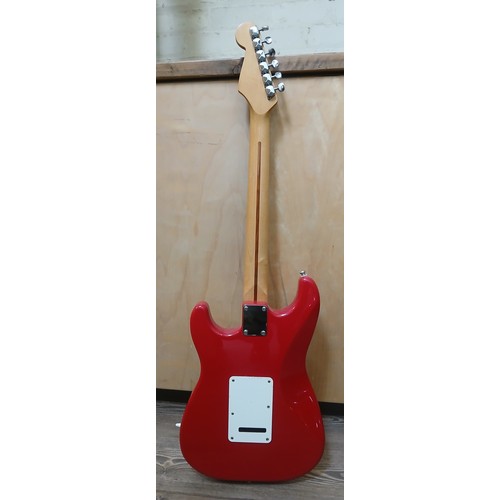 136 - A Fender Stratocaster Mexican electric guitar, red body with white pick guard, maple neck, made in M... 