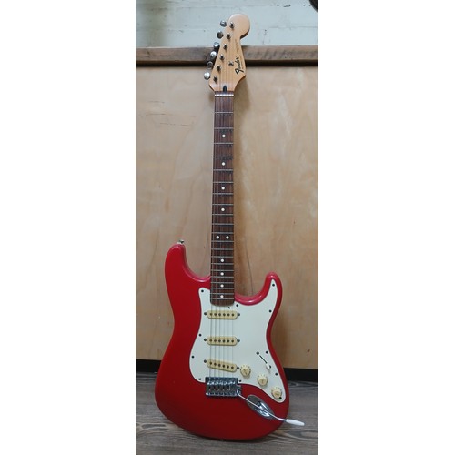 136 - A Fender Stratocaster Mexican electric guitar, red body with white pick guard, maple neck, made in M... 