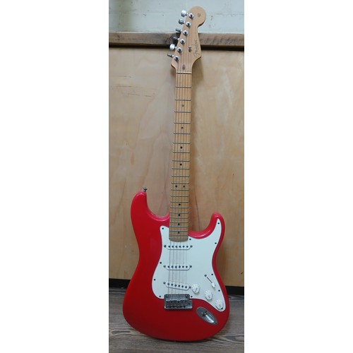 134 - A Fender Stratocaster electric guitar, made in the USA, red with white pick guard, maple neck, seria... 