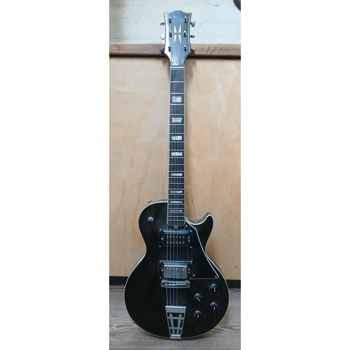 148 - A Les Paul style electric guitar with black lacquered finish, bolted on neck and black pick guard.