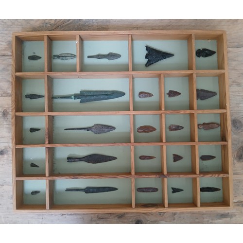 133 - A collection of flint and metal arrow heads, the case measuring approximately 45cm x 37cm.