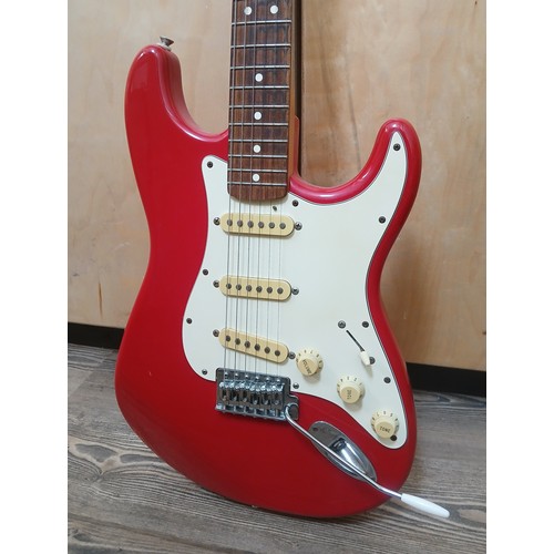 136 - A Fender Stratocaster Mexican electric guitar, red body with white pick guard, maple neck, made in M... 