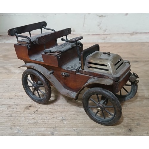 154 - A wood and brass model  car modelled as an early 20th century touring car with leather seats and rub... 