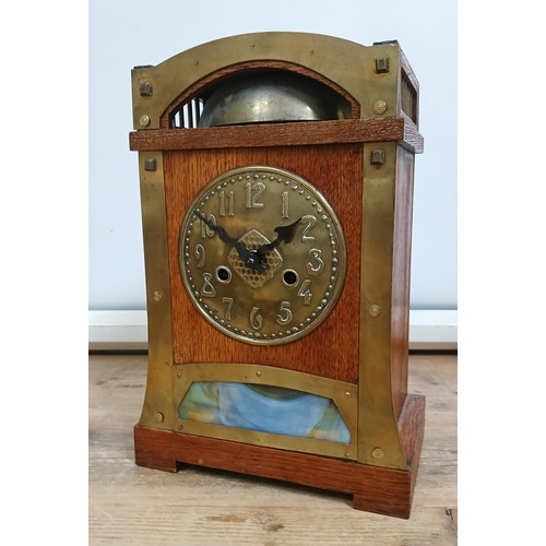 158 - A German Secessionist oak mantle clock, brass mounts and dial, glass panel, double spring driven mov... 