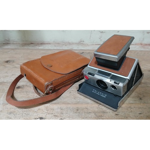 152 - A Polaroid SX70 camera.