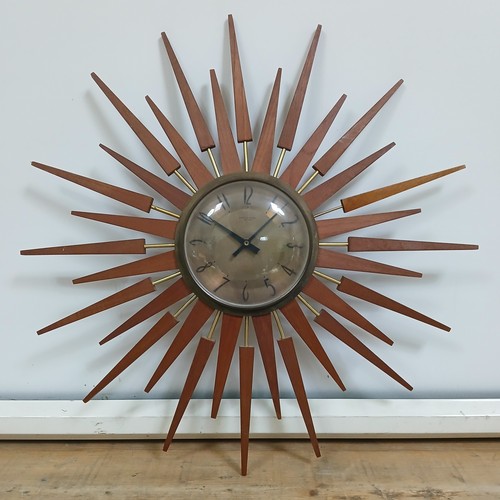 163 - A retro sunburst clock signed 'Anstey & Wilson', diameter 62cm.