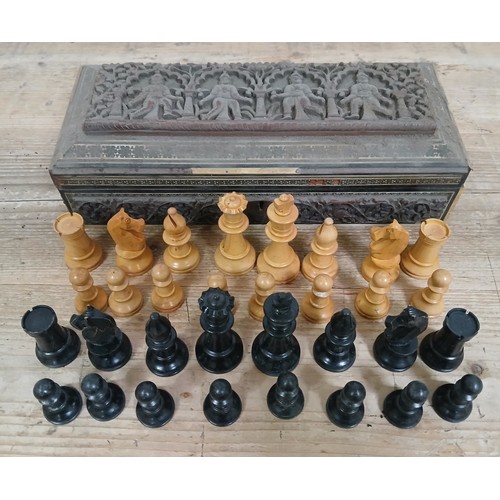 165 - An Indian 19th century Vizagapatam carved wood box containing a boxwood and ebonised chess set, king... 