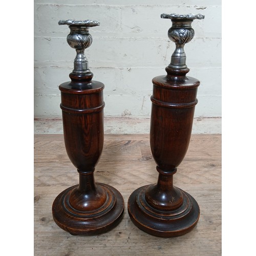 156 - A pair of turned wood bulbous candle sticks, stained beech with silver plated sconces, height 30cm.