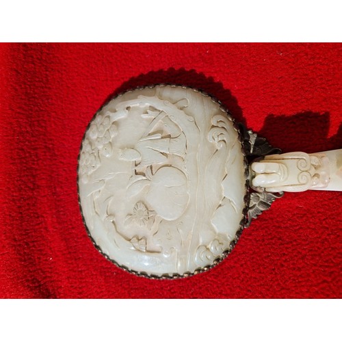 74 - An early 20th century Chinese carved jade and gilt metal mounted hand mirror, the 18th/19th century ... 