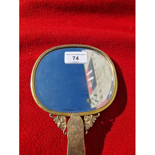 74 - An early 20th century Chinese carved jade and gilt metal mounted hand mirror, the 18th/19th century ... 