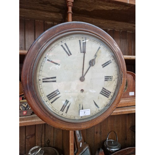 7 - A spring driven wall clock, diameter 38.5cm.