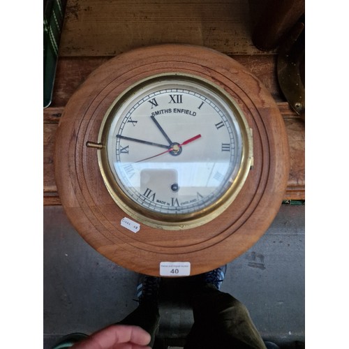 40 - A Smiths Enfield brass bulkhead clock on wooden mount, marked 'MADE FOR ROYAL NAVY, LONDON, 1920'.