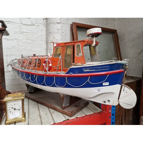 72 - A model lifeboat on stand, approx. 95cm long