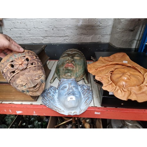 80 - Four assorted masks to include ceramic & wood etc.