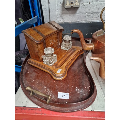 77 - An oak desk stand with glass inkwells together with an inlaid mahogany tray.