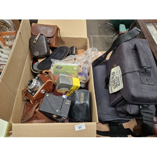 91 - A box containing cameras, cine film cameras, binoculars, gadget bags, includes Voightlander Vito, fo... 