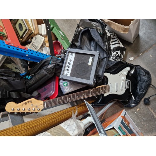 114 - A black Rock Star guitar with practice amp and accessories.