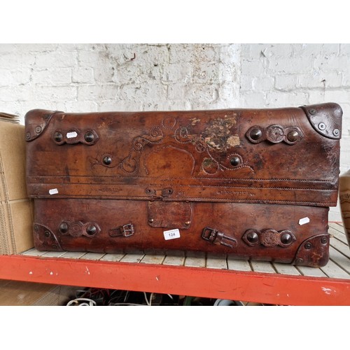 124 - A brown leather travel trunk, circa 1900.