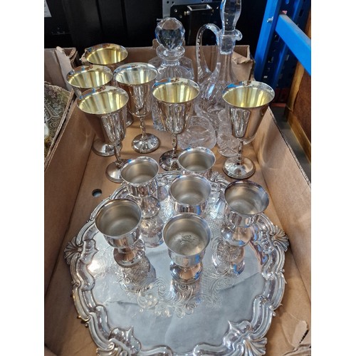 157 - A box of plated wares together with 2 cut glass decanters and glasses