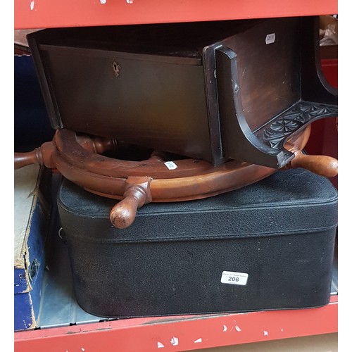 206 - A carved wood cabinet, a ship's teak wheel and a vintage case.