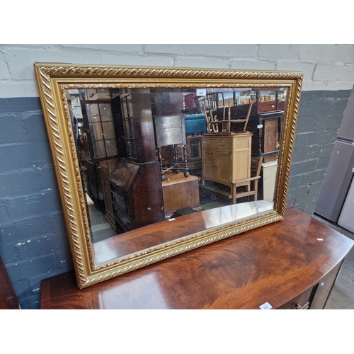 999 - A gilt framed mirror, 103cm x 72cm.