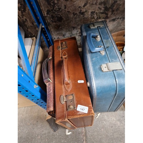 115 - A leather briefcase, a leather suitcase, and another suitcase, other household items including floor... 