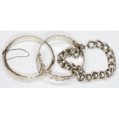 192 - Hallmarked silver comprising two bangles and a bracelet, weight 102.8g.