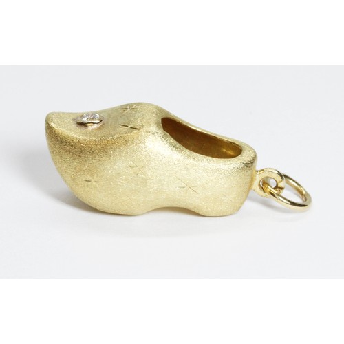 4 - A novelty charm or pendant modelled as a clog, textured finish and set with a single round brilliant... 