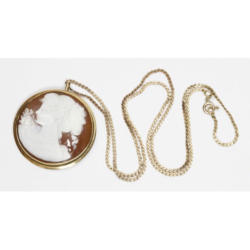 40 - A cameo pendant brooch, the shell cameo carved in relief depicting a female head and shoulders, yell... 