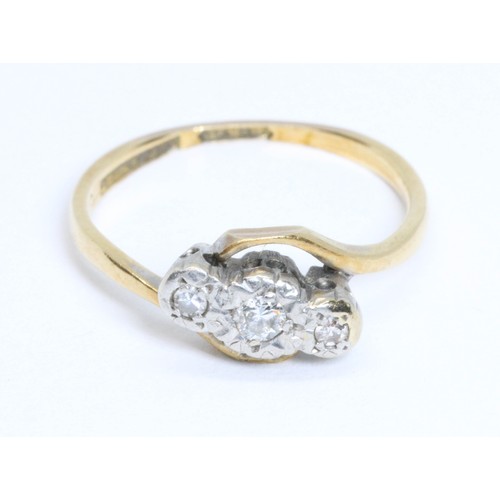 52 - A three stone diamond ring, white metal illusion setting, yellow band marked '18ctPLAT', gross weigh... 