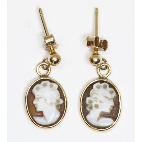 42 - A pair of yellow metal mounted shell cameo drops, length 13mm, unmarked, gross weight 1.4g.