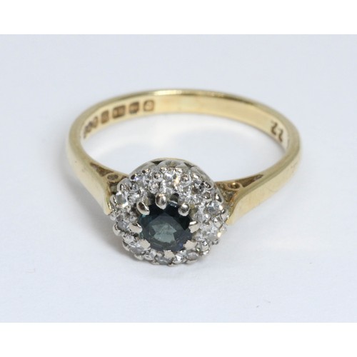 43 - A diamond and sapphire cluster ring, the central sapphire weighing approximately 0.40cts, surrounded... 