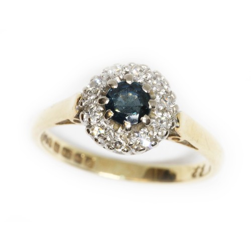 43 - A diamond and sapphire cluster ring, the central sapphire weighing approximately 0.40cts, surrounded... 