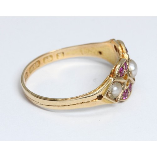 135 - A Victorian split pearl and ruby ring, hallmarked 15ct gold, sponsor 'A.A', Birminggham 1870, gross ... 