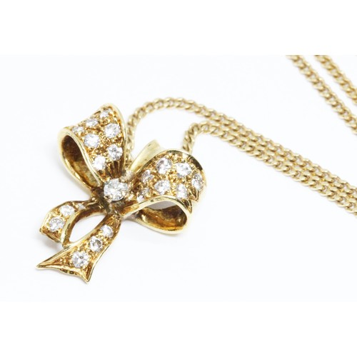 132 - CROPP & FARR, an 18ct yellow gold diamond pendant necklace, modelled as a bow and set with 21 round ... 