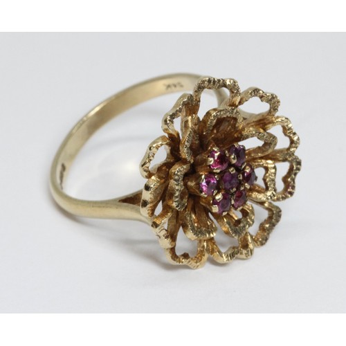 150 - A 9ct yellow gold ruby cluster ring, textured flower head set with seven small stones, hallmarked; s... 