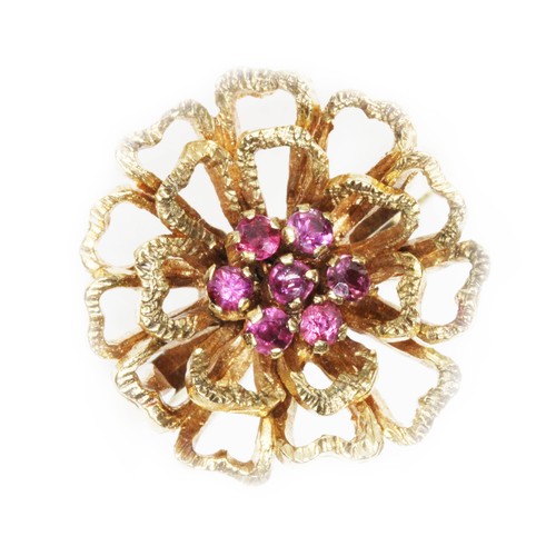 150 - A 9ct yellow gold ruby cluster ring, textured flower head set with seven small stones, hallmarked; s... 