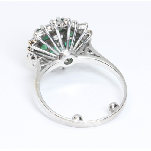 151 - A mid 20th century diamond and emerald cocktail ring, the central round brilliant cut stone weighing... 