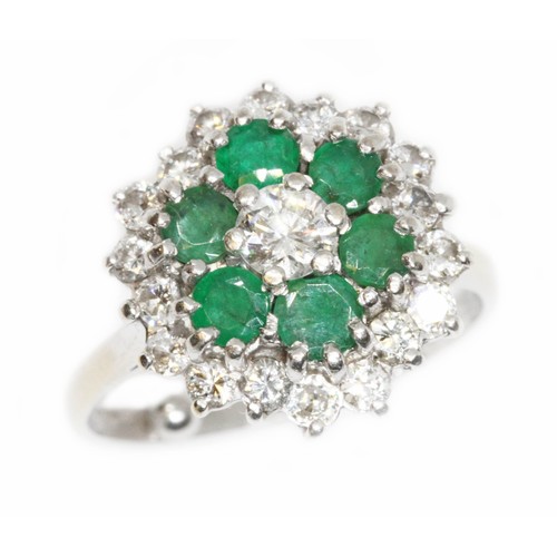 151 - A mid 20th century diamond and emerald cocktail ring, the central round brilliant cut stone weighing... 