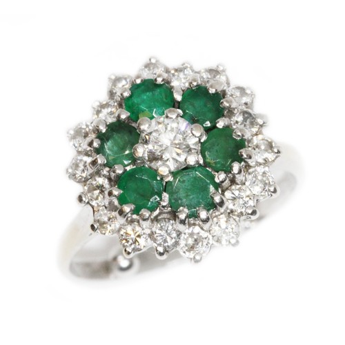 151 - A mid 20th century diamond and emerald cocktail ring, the central round brilliant cut stone weighing... 