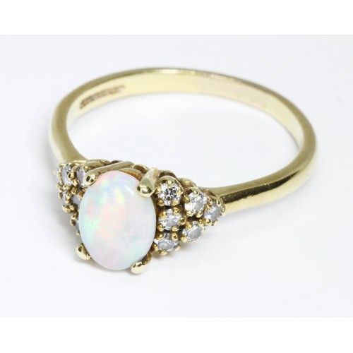 164 - An 18ct yellow gold opal and diamond ring, the central oval cabochon measuring approximately 8.10mm ... 