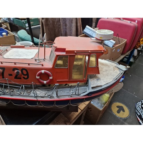 72 - A model lifeboat on stand, approx. 95cm long