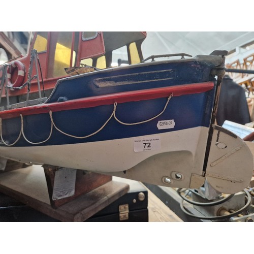 72 - A model lifeboat on stand, approx. 95cm long